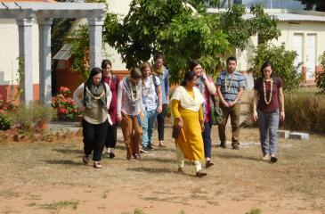 Students walk outdoors around the campus of Indian hosting organization SVYM