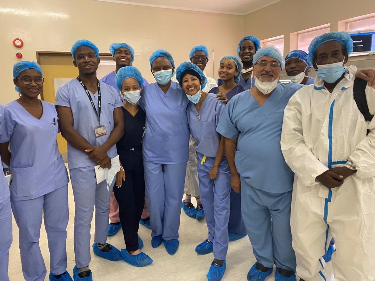 Rahel Nardos stands smiling with a surgical care team at a hospital in Ethiopia