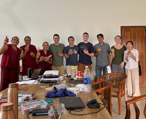 Richard MacLehose (fourth from left), Tenzin Namdul (fifth from left), and the rest of the study staff celebrate the launch of their study with fruit gifted to them by a participant.